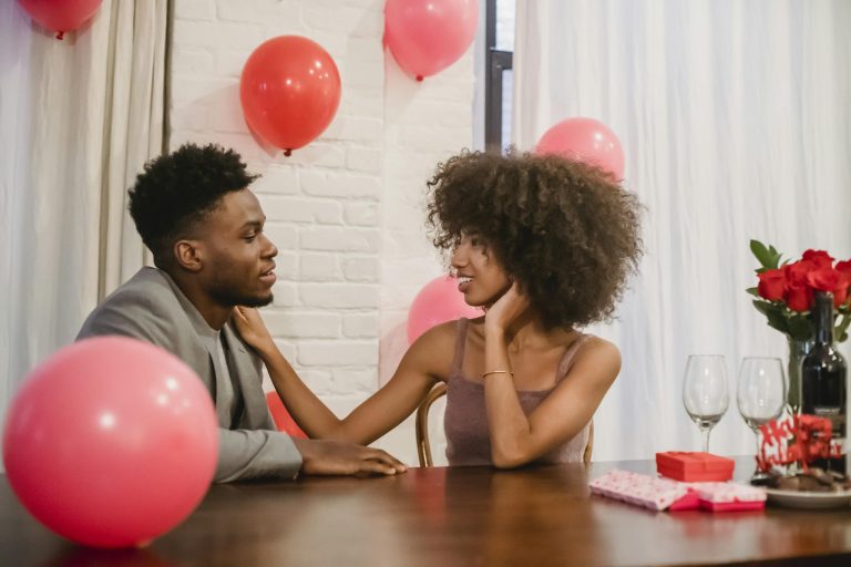 African American couple having date at table with presents